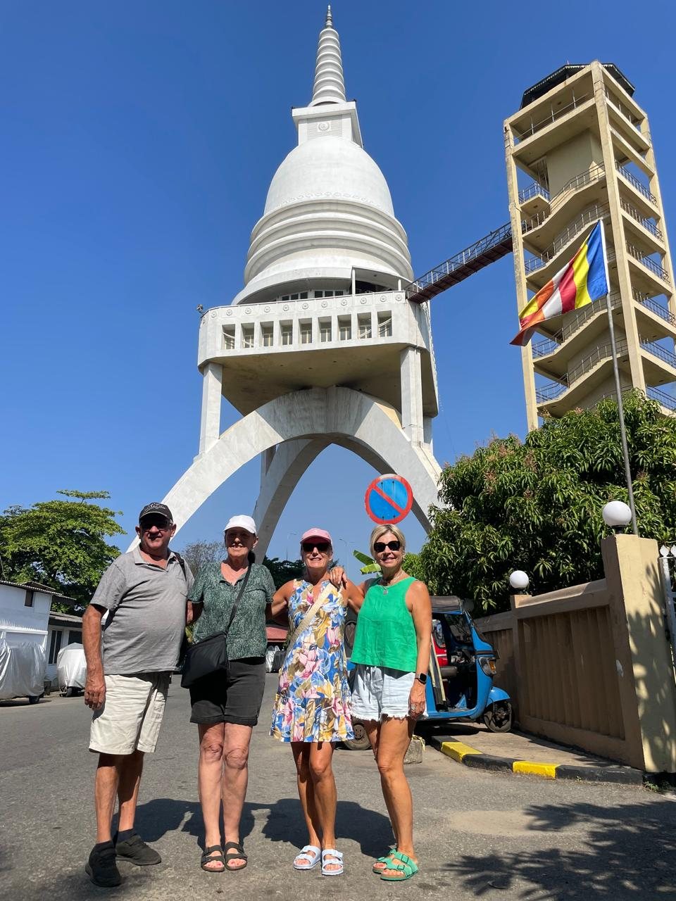 Travellers visiting a Buddhist stupa during a Colombo city tour