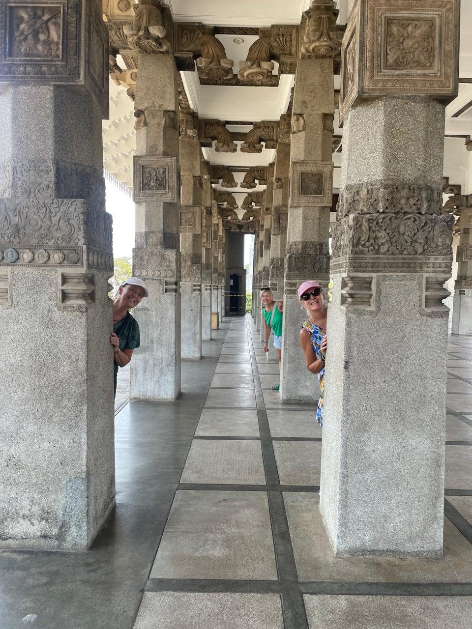 Travellers exploring the carved pillars of Independence Memorial Hall in Colombo