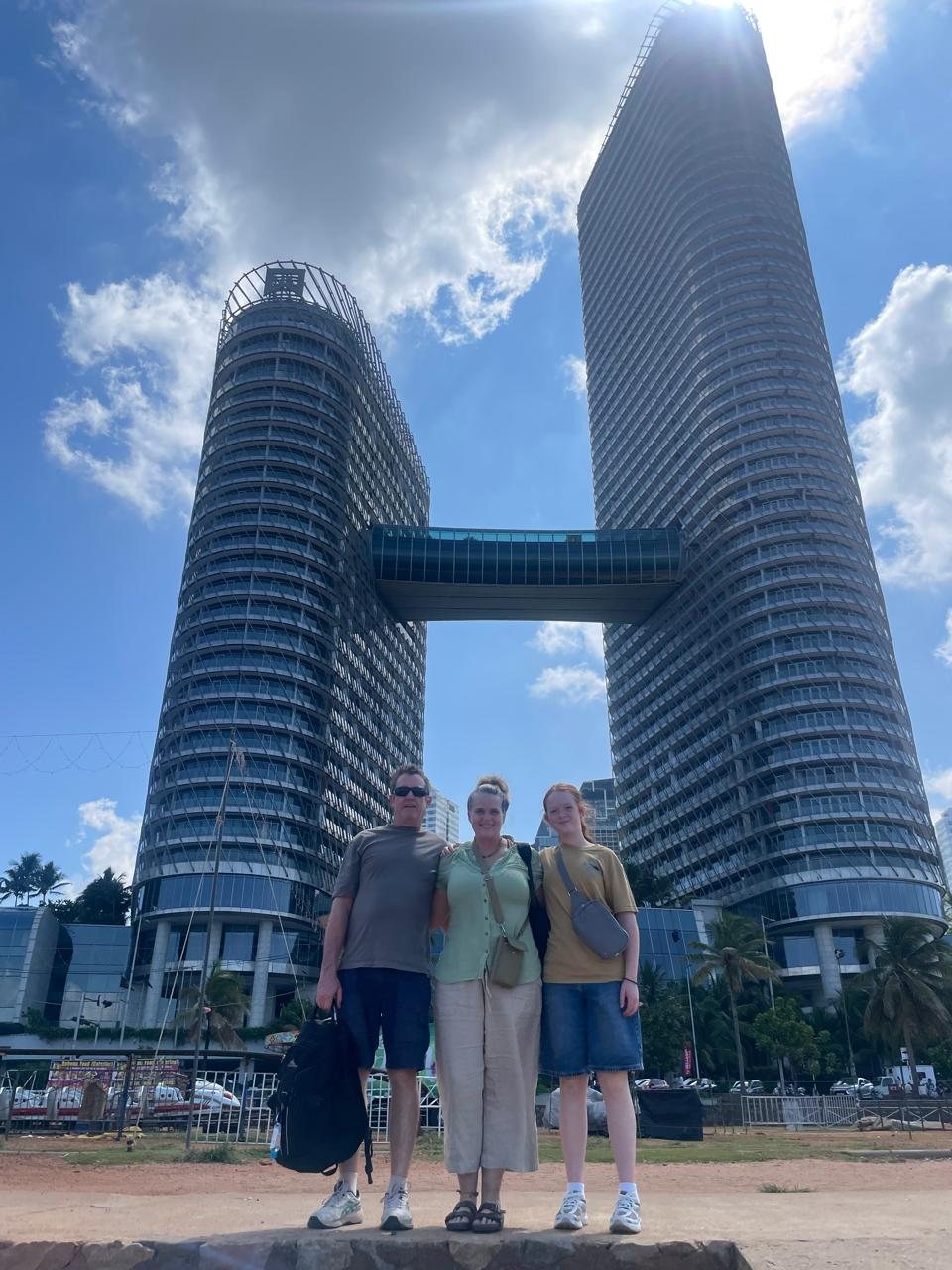 Travellers standing beneath Colombo's modern skyline